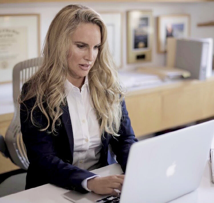 Wendy Manard typing at computer - Personal Injury Attorney New Orleans Louisiana